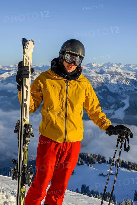 Skier standing at the ski slope holding ski