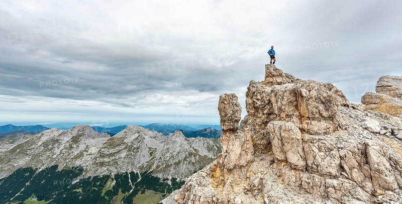 Mountaineer stands on a rock