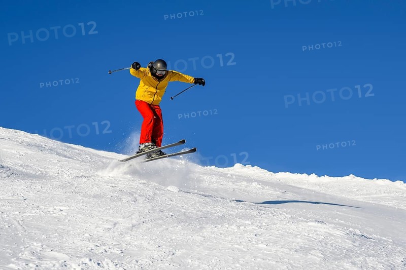 Skiers jumping on the ski slope