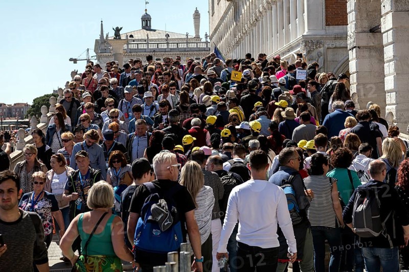 Tourists on the Ponte de Paglia visit the Bridge of Sighs