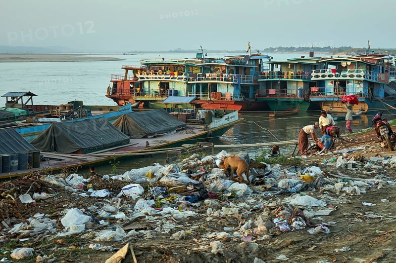 Garbage and ships at the river bank