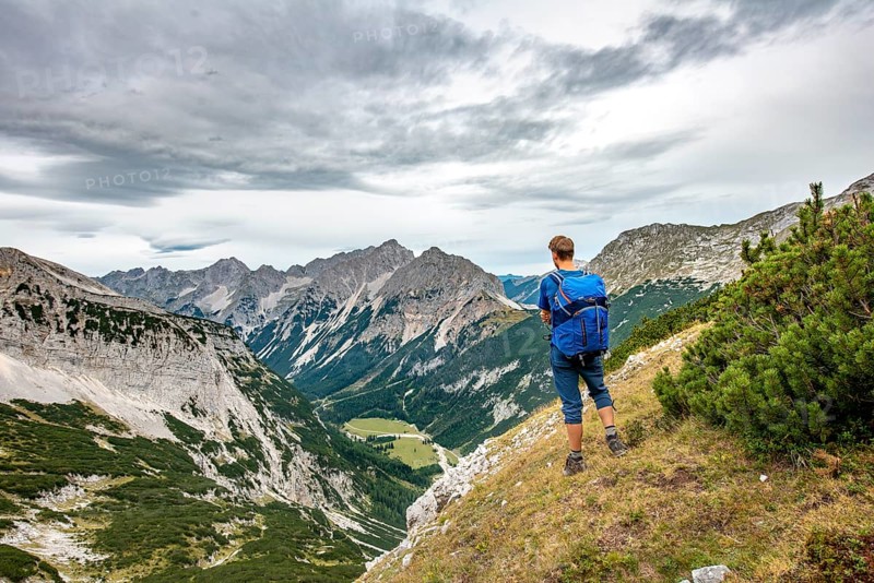 Hiker looks into the Karwendel valley with Raffelspitze and Hochkarspitze