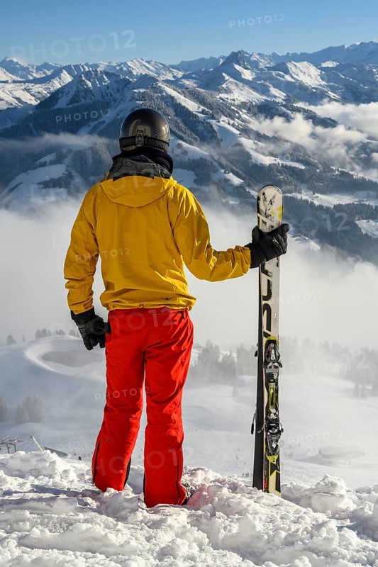 Skier standing at the ski slope holding ski