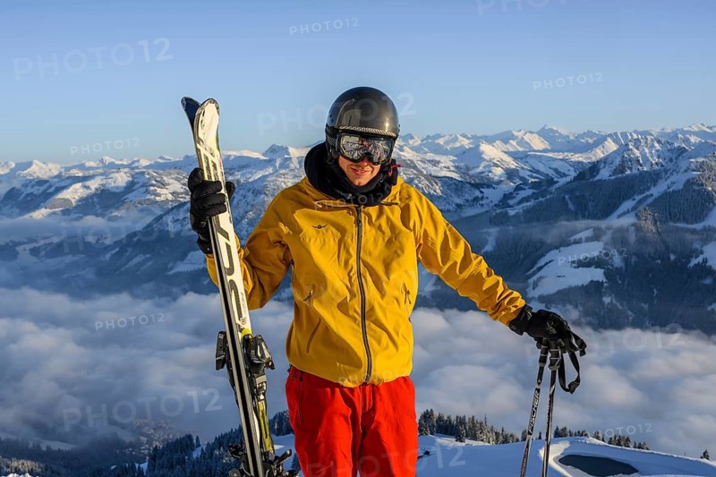 Skier in front of mountain panorama