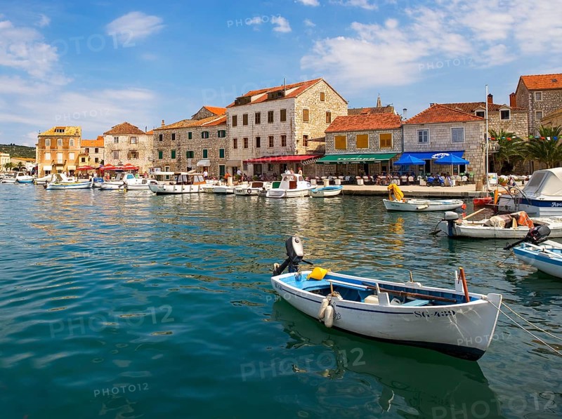 Promenade with fishing boats in the port