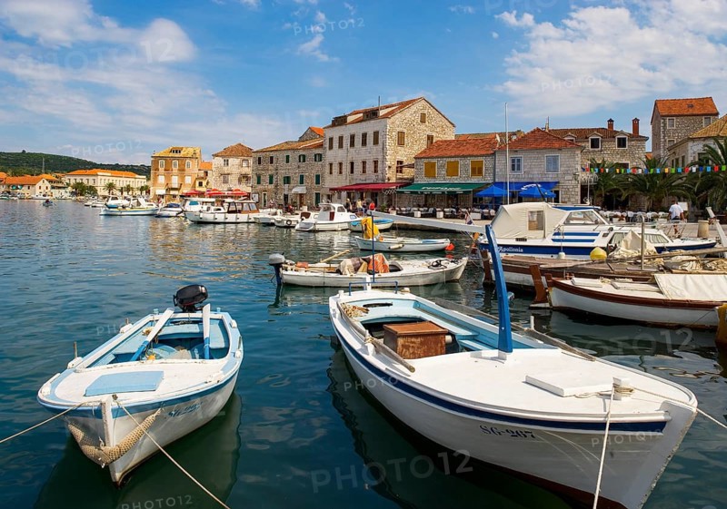 Promenade with fishing boats in the port