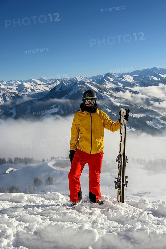 Skier standing at the ski slope holding ski