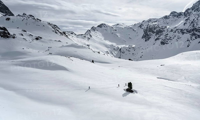 Ski tourers cross a flat slope