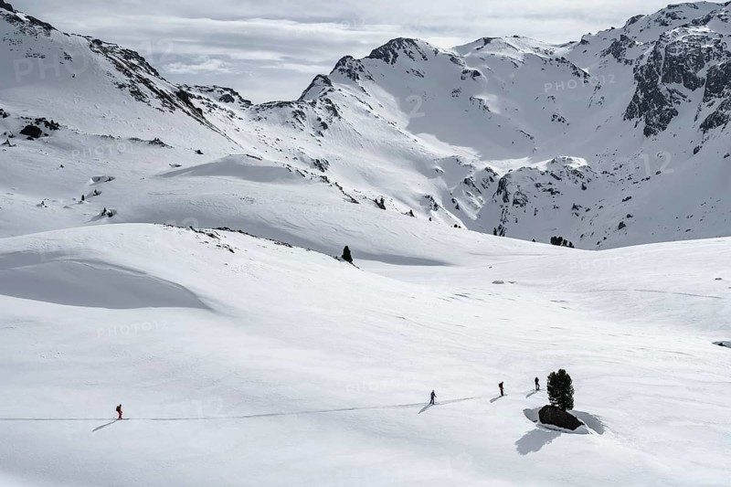 Ski tourers cross a flat slope