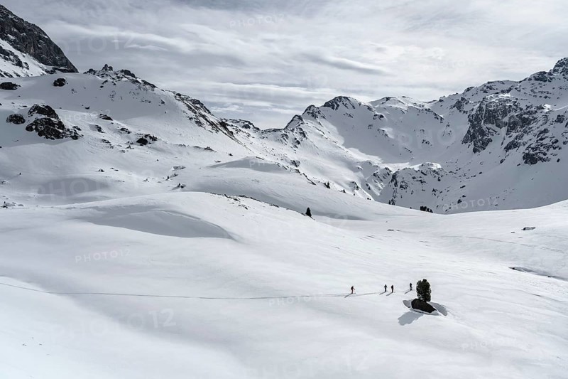 Ski tourers cross a flat slope