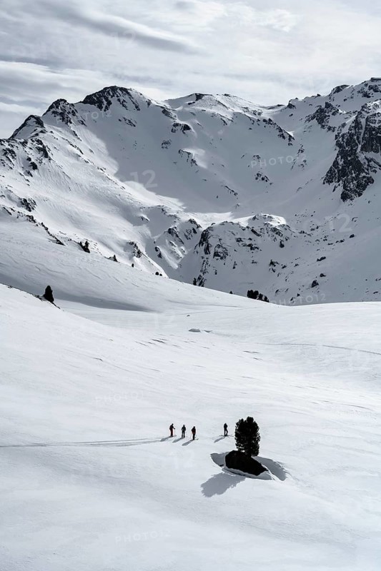 Ski tourers cross a flat slope