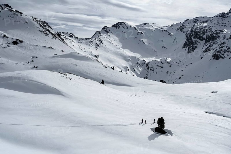 Ski tourers cross a flat slope