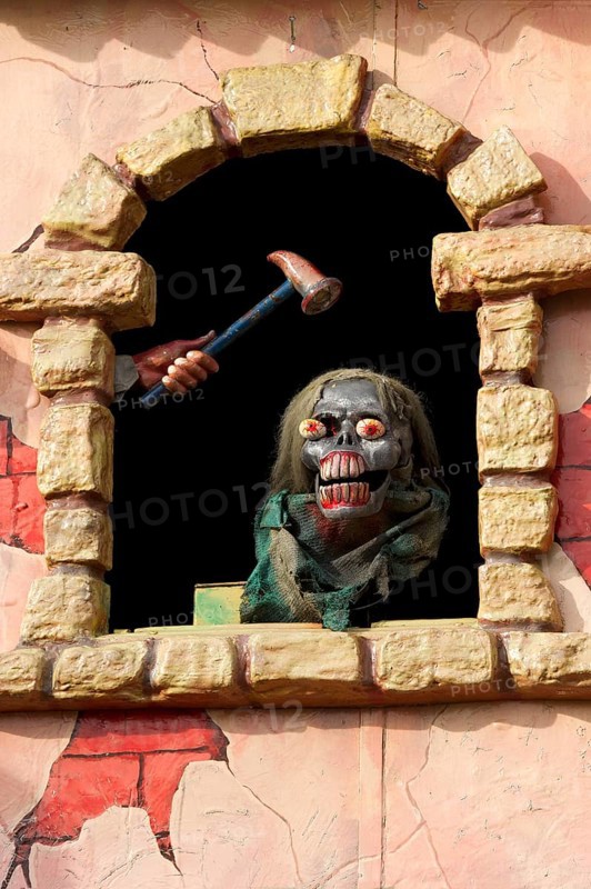 Horror figure in window on ghost train at the Wiesn