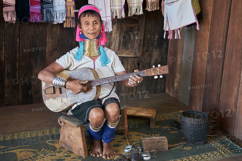 Folk group Padaung woman plays guitar and sings