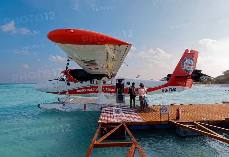 Passengers boarding seaplane De Havilland Canada DHC-6 Twin Otter of Maldivian Airlines