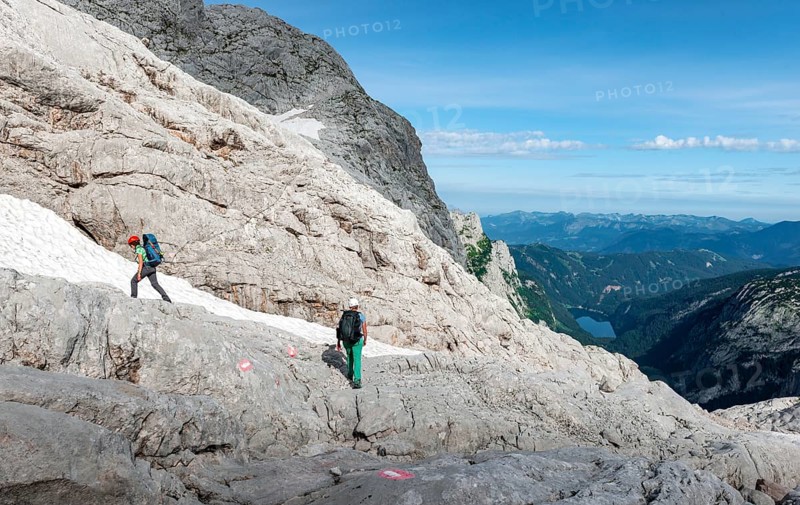 Female mountaineers on a marked route through rocky alpine terrain