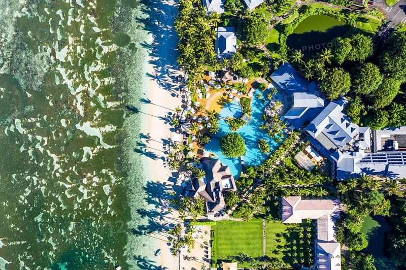 The beach of Flic en Flac with the luxury hotel Sugar Beach Golf & Spa Resort and palm trees