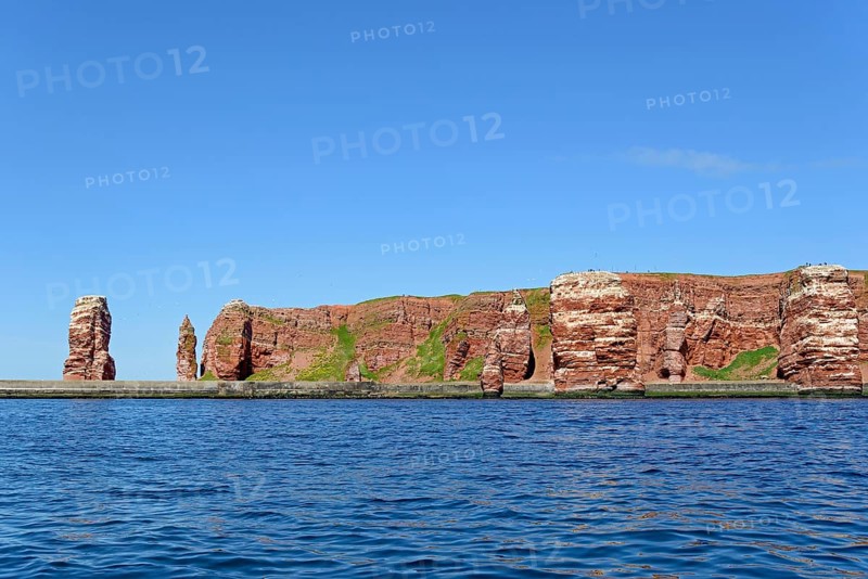 View from the water to the red sandstone rocks with Langer Anna