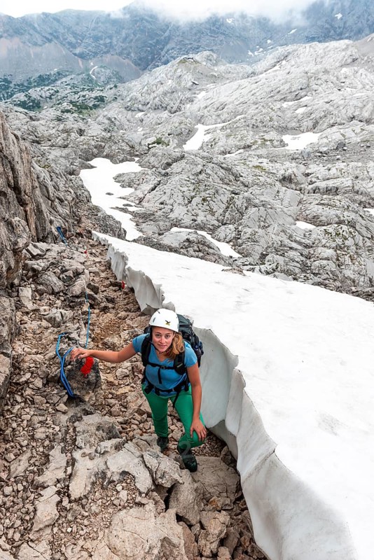 Mountaineer on secured route next to snow field from Simonyhuette to Adamekhuette