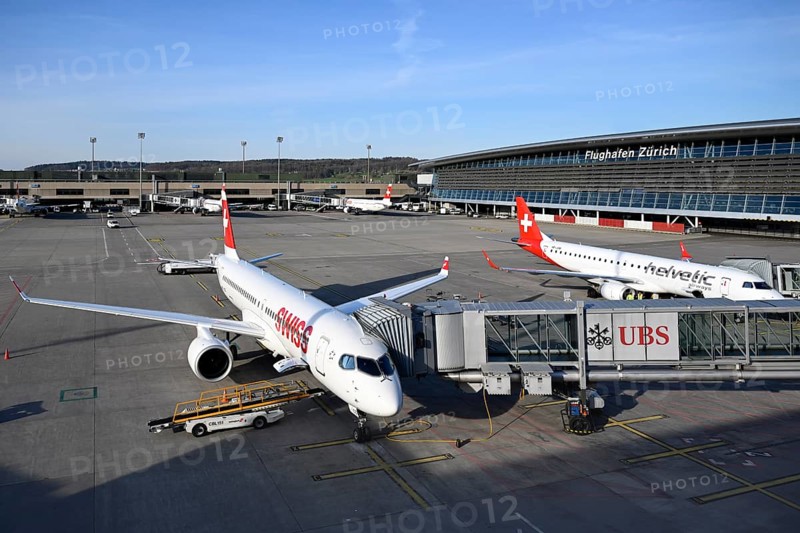 Zurich Airport with aircraft Swiss Airbus A220-300 HB-JCS and Helvetic Airways Embraer ERJ-190 HB-JVM