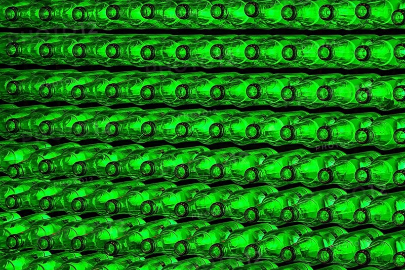 Empty green beer bottles on the conveyor belt