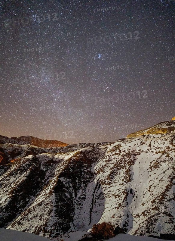 Starry sky over snowy mountains