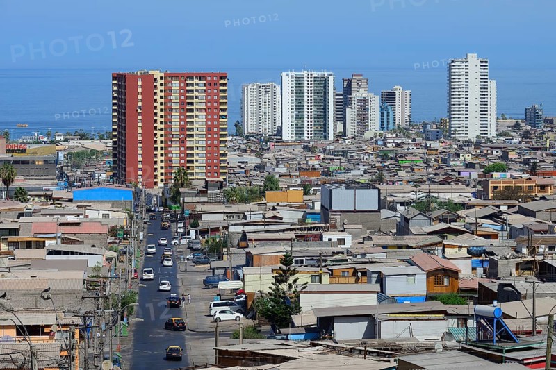 Typical simple residential buildings in front of skyscrapers