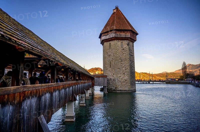 View over the river Reuss to the Chapel Bridge and Water Tower in the evening light