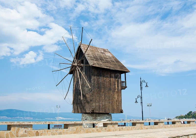Wooden windmill and monument near historical centre of the town Nesebar