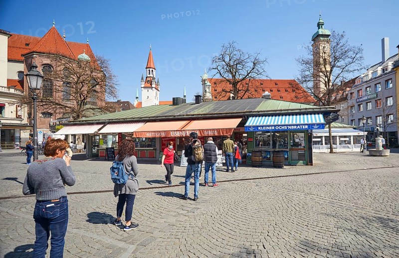 Queue of people with a safe distance in front of food stalls at Viktualienmarkt