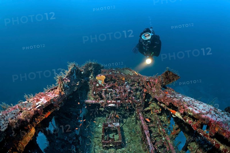 Diver views cockpit at aircraft wreck