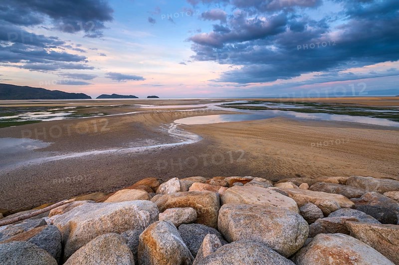 Evening mood at low tide, sand formations on the coast of Torrent Bay