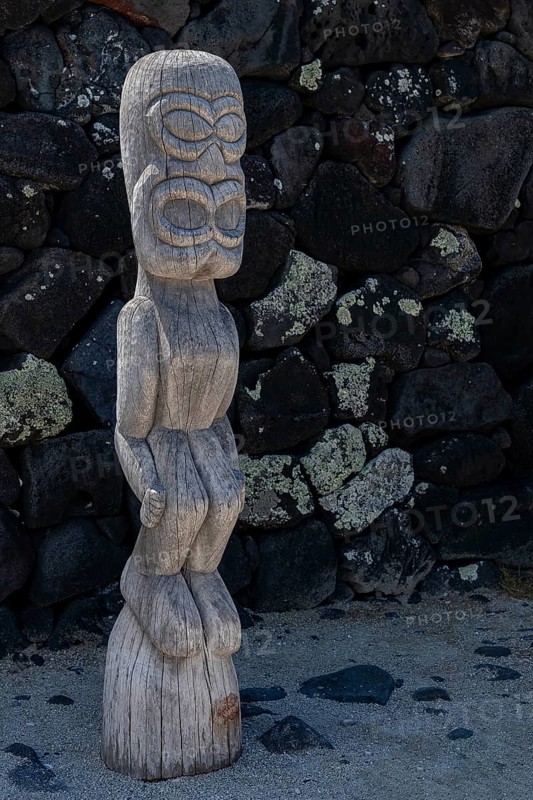 Guardian wooden tiki in front of big wall, Pu'uhonua O Honaunau National Historical Park
