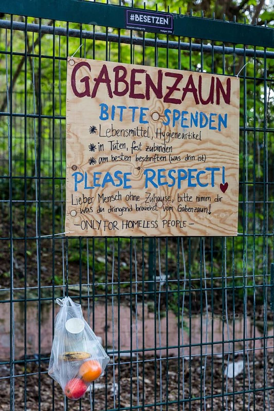 Gift fence, bag with food for the needy hangs on wire fence
