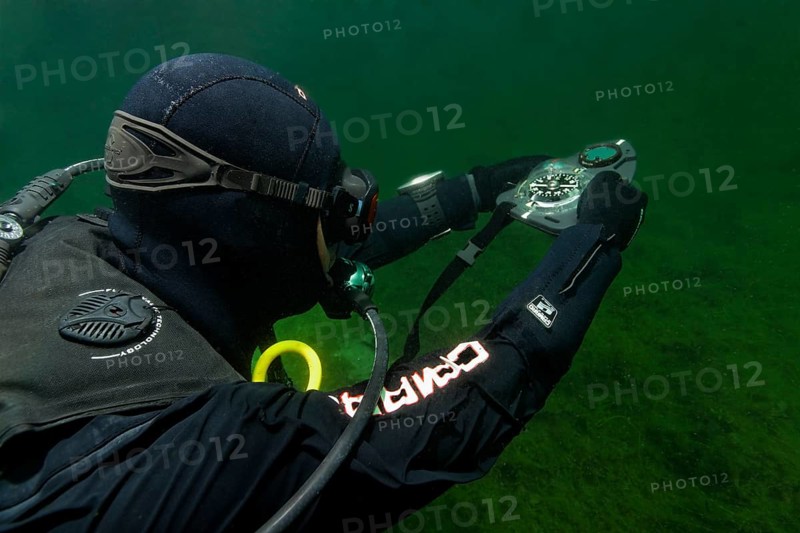 Divers in dry suits orientate themselves with compass in waters with poor visibility, Echinger Weiher