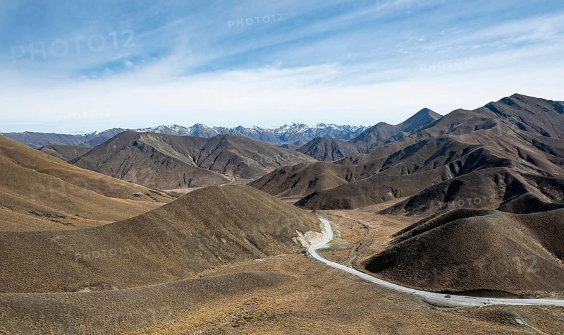 Barren mountain landscape with pass road, Lindis Pass