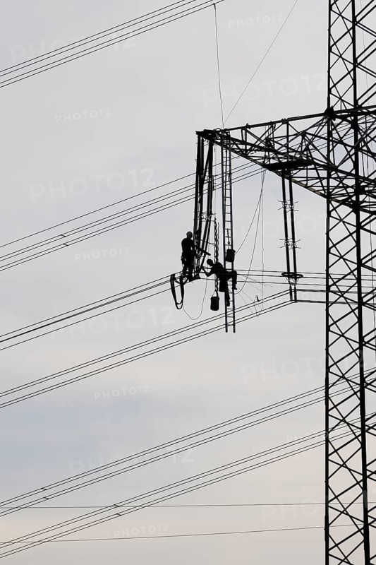 High voltage engineers working on high voltage pylons, Baden-Wuerttemberg