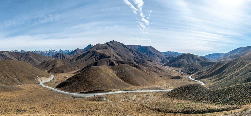 Barren mountain landscape with pass road, Lindis Pass