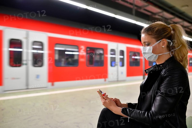 Woman with face mask, on mobile phone