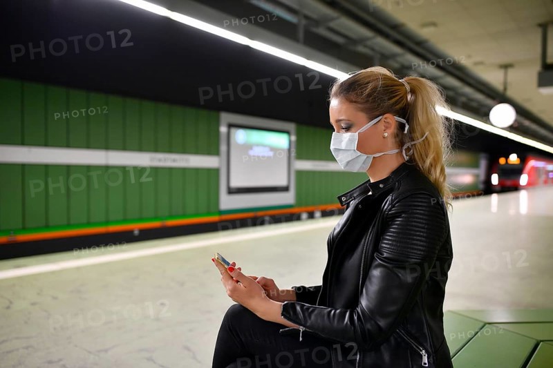Woman with face mask, on mobile phone
