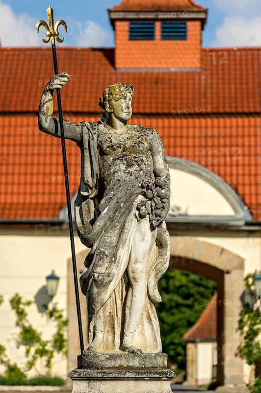 Sculpture of the sea god Neptune at the Neptune Fountain, farm yard in the baroque castle Fasanerie