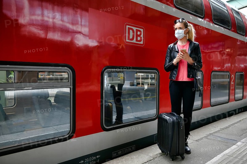 Woman with face mask, waiting for train