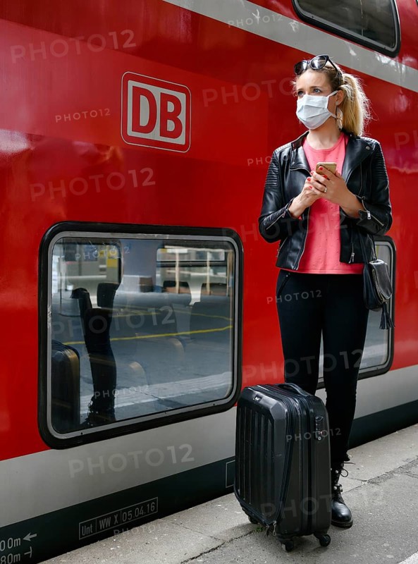Woman with face mask, waiting for train
