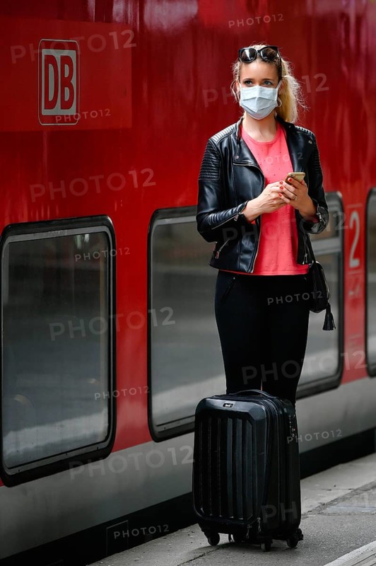 Woman with face mask, waiting for train