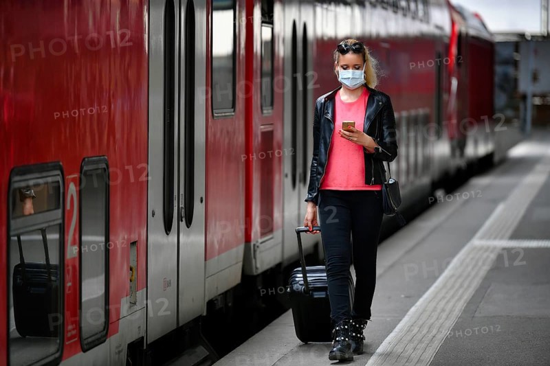 Woman with face mask, waiting for train