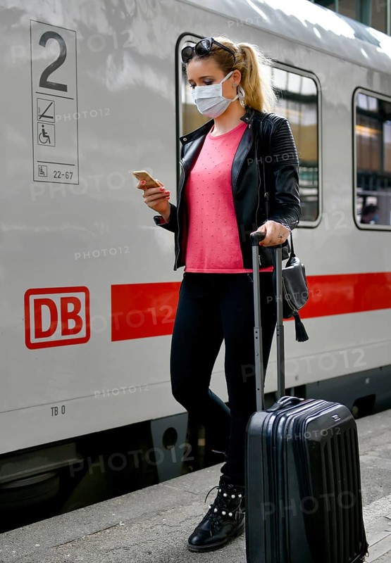 Woman with face mask, waiting for train