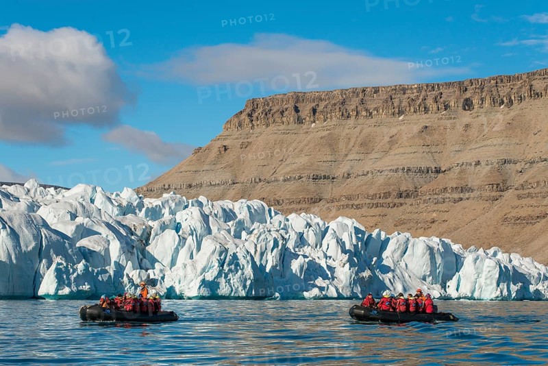 Rubber dinghies with tourists in front of glaciers, Croker Bay