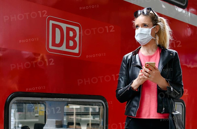 Woman with face mask, waiting for train