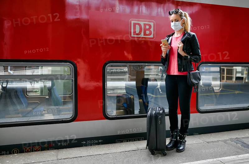 Woman with face mask, waiting for train