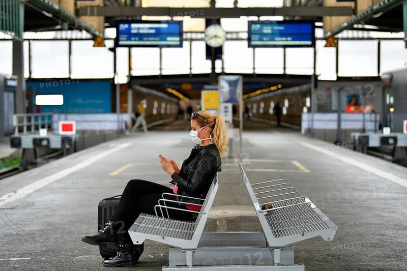 Woman with face mask, waiting for train
